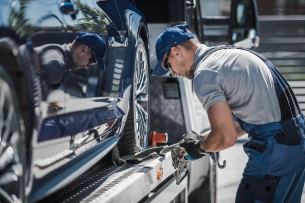 tow-truck-driver-securing-loaded-car-for-safe-delivery.jpg